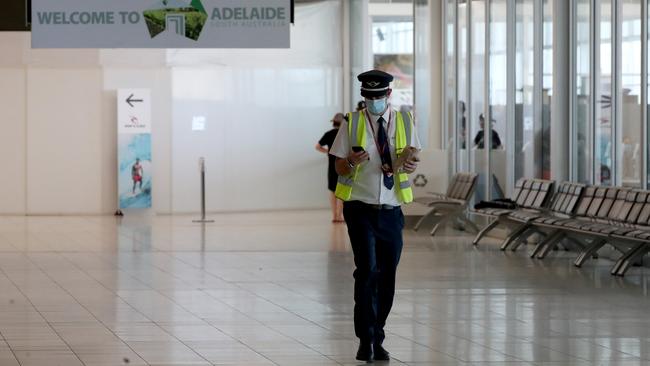 A pilot walks through a now quiet terminal at Adelaide Airport on Wednesday November 18. Picture: Getty Images