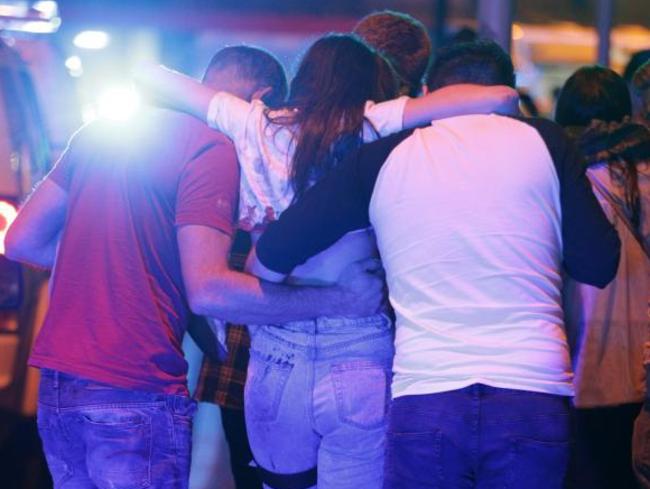 Concertgoers help those injured out of the arena. Picture: Joel Goodman/LNP