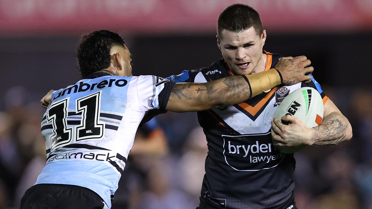 SYDNEY, AUSTRALIA - JULY 12: John Bateman of the Wests Tigers is tackled during the round 19 NRL match between Cronulla Sharks and Wests Tigers at PointsBet Stadium on July 12, 2024, in Sydney, Australia. (Photo by Brendon Thorne/Getty Images)