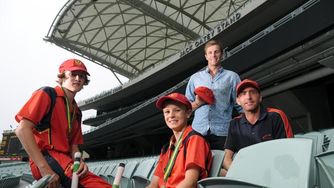 Ethan Trewartha (centre) with SAPSASA teammate Will Patton, ex-player Gary Putland and coach Derek Woodcock. Ethan tops the under-14 red batting and bowling averages. Picture: AAP/Morgan Sette