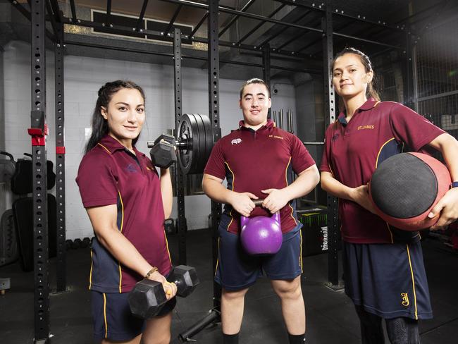 Yasmin Moghadas (L), Harrison Goodeve and Nilofar Moheb posing at St James College, 201 Boundary Street, Fortitude Valley, Brisbane, 3rd of March 2020. (AAP Image/Attila Csaszar)