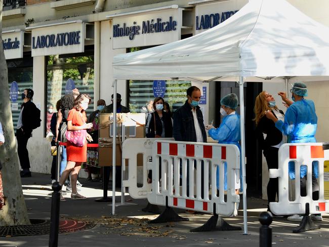 People wait in line outside a medical laboratory in Paris to be tested for COVID-19. Picture: AFP.