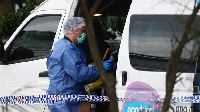 Police officers attend Hambledon State School at Edmonton, where a 3 year old was found dead in a Goodstart Early Learning Centre minibus at around 3:30pm on Tuesday. A police forensic officer inspects the van. PICTURE: BRENDAN RADKE