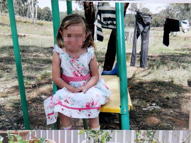 Playtime: One of Betty Colt’s daughters poses for the camera on a set of play equipment bought by the family. Their pants and shirts are hung on a makeshift clothesline in the background, stretched out between the trees.