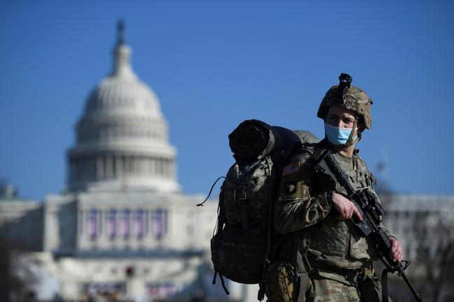 A member of the National Guard mounts guard near the U.S. Capitol building, as the House of Representatives debates impeaching U.S. President Donald Trump a week after his supporters stormed the Capitol building in Washington, U.S., January 13, 2021. REUTERS/Brandon Bell