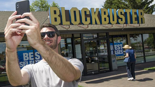 File - In this July 13, 2018 file photo, Scott Thornton takes a selfie in front of the Bend, Ore., Blockbuster. The Blockbuster store in Bend, Oregon became the last one in the US last year. And now it's the only one in the world. The Bulletin reports that a Blockbuster store in Perth, Australia is closing later this month, leaving the Bend franchise alone on the planet. (Ryan Brennecke /The Bulletin via AP, File)