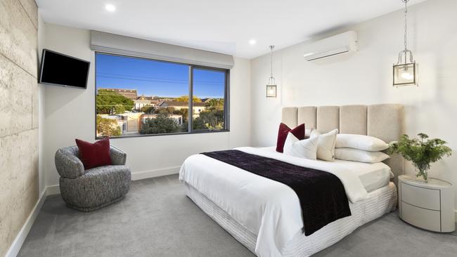 The rammed earth is also on show in the main bedroom suite.