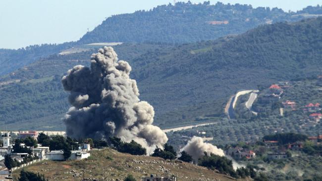 A smoke plume rises over the southern Lebanese village of Kfar Kila during Israeli bombardment.