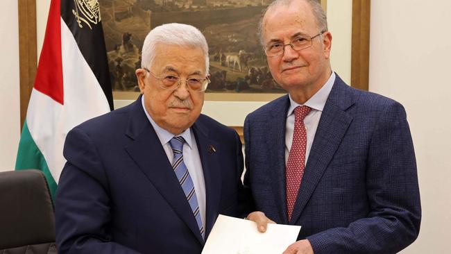 Palestinian President Mahmoud Abbas (L) poses with the newly appointed Palestinian Prime Minister Mohammad Mustafa, in Ramallah. Picture: PPO/AFP.