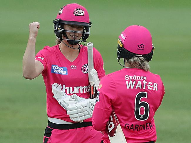 Ellyse Perry and Ash Gardner celebrate the win. Picture: Mark Metcalfe/Getty