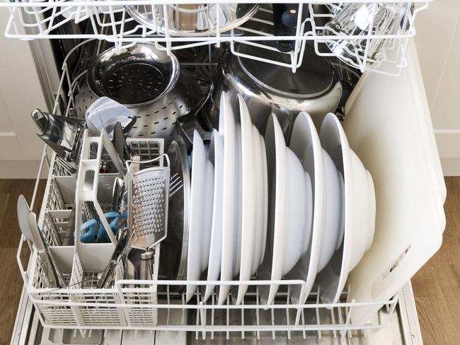 Dishwasher stacked with dishes.