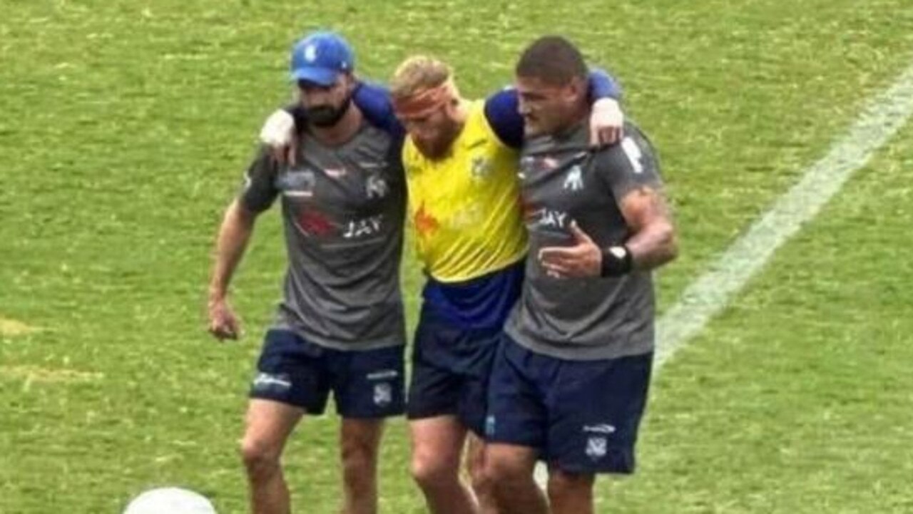 Thompson being helped off after sustaining a lisfranc injury at training.