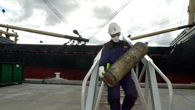 A gas cylinder is carried off the Pong Su for inspection by forensic police.