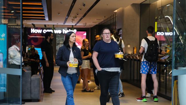 Unhappy customers leave the Optus shop on George St in the Sydney CBD during the nationwide outage. Picture: NCA NewsWire / Gaye Gerard