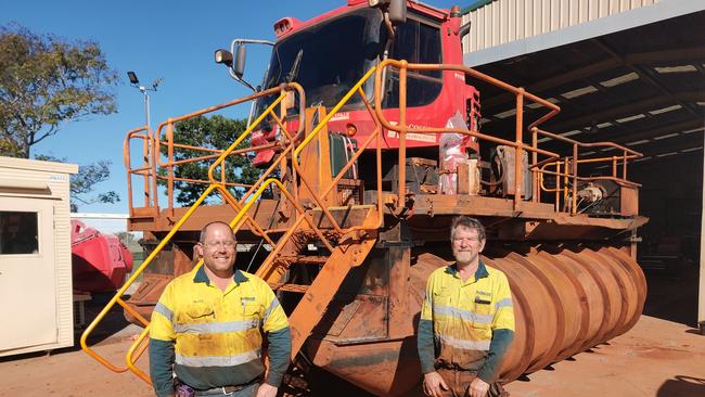 McCoskers Contractors employees from left, Matt Baldwin and Bob McKenzie with the $1 million Gladstone designed engineered and constructed bouyant scrolling machine used to extend mining tailings dam walls. Picture :Rodney Stevens