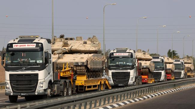 Israeli tanks are transported on a road near Sderot, in the country’s south, after the deadliest attack on its territory in half a century. Picture: AFP