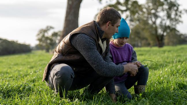 Ricky Luhrs from Hamilton checks pastures with his daughter Ivy, 8.