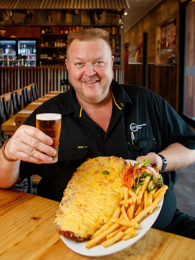 Yorky pictured with the classic Parmy schnitzel and a pint in their newly refurbished pub. Picture: Matt Turner