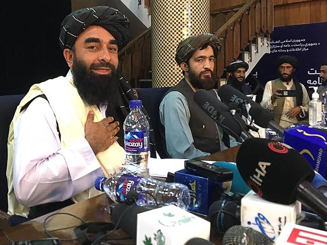 Taliban spokesperson Zabihullah Mujahid, left, gestures as he arrives to hold the first press conference in Kabul on August 17. Picture: AFP