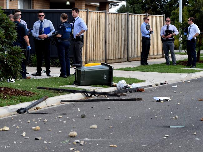 Metal poles and rocks and strewn across the street. Picture: Nicole Garmston