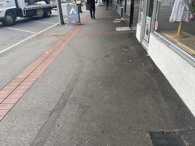 The tyre marks the vehicle left on the footpath near the shops on Smith St. Picture: Jack Colantuono