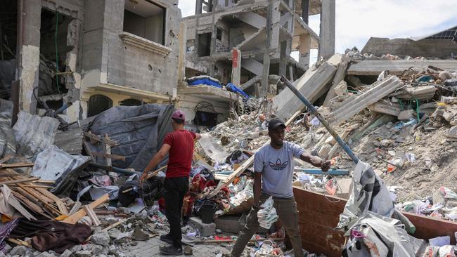 People look for salvageable items in the rubble of a building hit in an Israeli strike in Jabalia in the northern Gaza Strip on Thursday. Picture: AFP