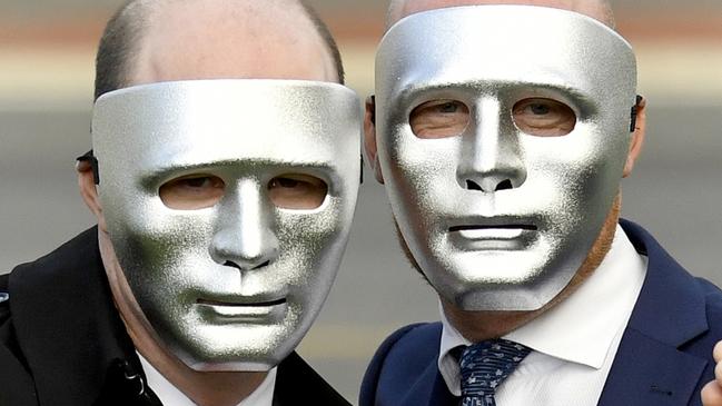 Masked brothers known as 'A' and 'B' pose for a photograph outside the Supreme Court in Adelaide on Monday, July 1, 2019. The Court of Criminal Appeal rejected convicted paedophile Vivian Deboo's bid to serve his sentence on home detention. (AAP Image/Sam Wundke) NO ARCHIVING