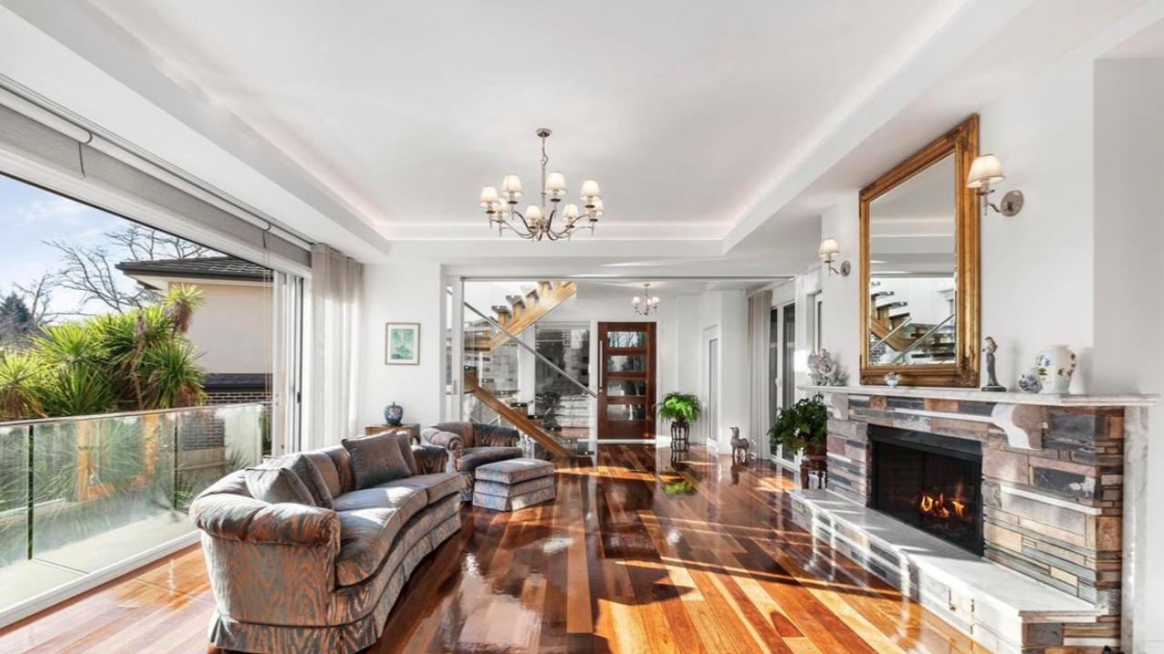 A formal lounge with an ambient fireplace provides a quiet retreat and adds refined charm to the versatile floorplan.
