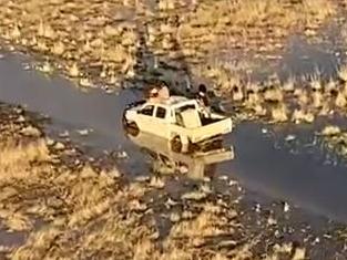 A father and his 10-year-old son have been rescued from floodwaters in remote northwest Queensland after their travel companions walked for 12 hours to raise the alarm. Picture: RACQ LifeFlight Rescue