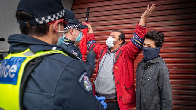 A lone protester speaks with police. Picture: Jake Nowakowski