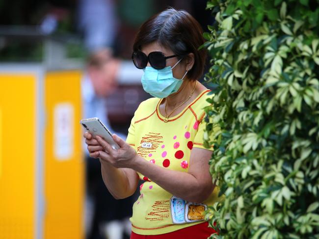 A woman wears a mask in the Brisbane CBD. Picture: AAP