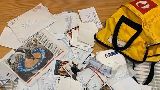 Some of the mail and the Australia Post delivery bag that was found dumped on Clontarf Beach. Picture: Felecia Tappenden