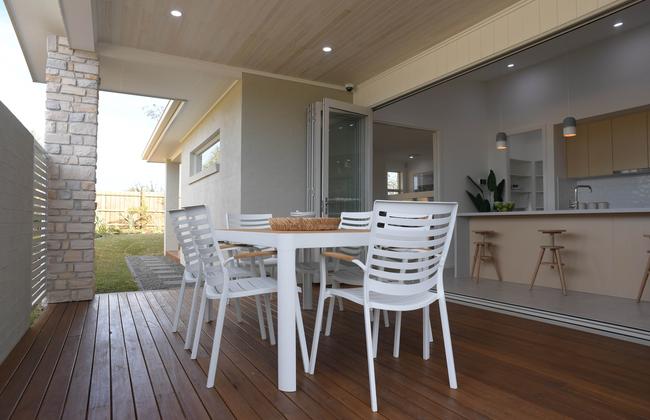 Side patio off the kitchen provides an extension of the living area.