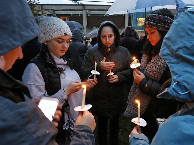 Holding candles, a group of girls wait for the start of a memorial vigil at the intersection of Murray Ave. and Forbes Ave. in the Squirrel Hill section of Pittsburgh, for the victims of the shooting at the Tree of Life Synagogue where a shooter opened fire, killing multiple people and wounding others, including sevearl police officers, Saturday, Oct. 27, 2018. (AP Photo/Gene J. Puskar)