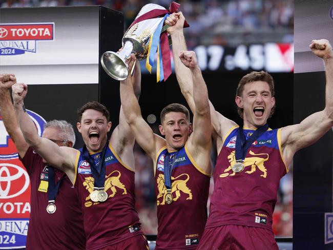 MELBOURNE, AUSTRALIA - SEPTEMBER 28: Chris Fagan, Senior Coach of the Lions, Lachie Neale, Dayne Zorko and Harris Andrews of the Lions celebrate with the 2024 AFL Premiership Cup after winning the AFL Grand Final match between Sydney Swans and Brisbane Lions at Melbourne Cricket Ground, on September 28, 2024, in Melbourne, Australia. (Photo by Daniel Pockett/AFL Photos/Getty Images)