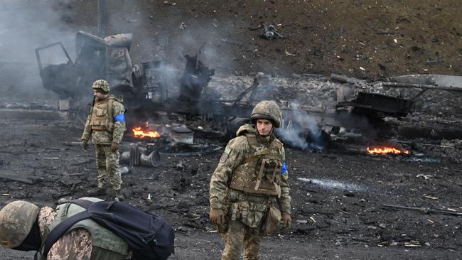 krainian service members look for and collect unexploded shells after a fighting with Russian raiding group in Kyiv. Picture: AFP