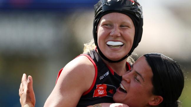 PERTH, AUSTRALIA - SEPTEMBER 07: Chloe Adams of the Bombers celebrates a goal with teammates during the 2024 AFLW Round 02 match between the West Coast Eagles and the Essendon Bombers at Mineral Resources Park on September 07, 2024 in Perth, Australia. (Photo by Will Russell/AFL Photos via Getty Images)