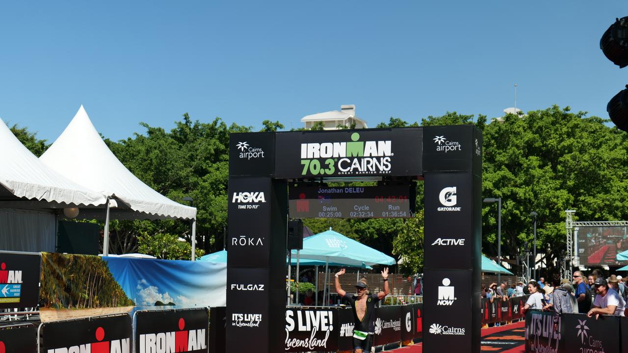 Cairns Ironman 70.3 competitor Jonathan Deleu crossing the finish line. Photo: Georgia Clelland.