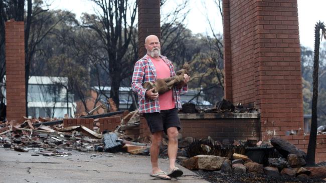 Peter Inkster recovered his 84-year-old mother-in-law’s statue from her burnt out Tathra property on Wednesday. Picture: Gary Ramage