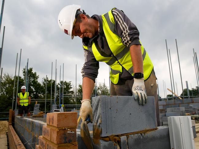 A bricklayer uses wearable technology, which vibrates when wearer breaches social distancing guidelines, on a Bewley Homes Plc residential construction site in Ash, near Farnborough, U.K. on Friday, June 12, 2020. New practices on construction sites will incorporate social distancing and workers in two-person tasks will use personal protective equipment. Photographer: Luke MacGregor/Bloomberg