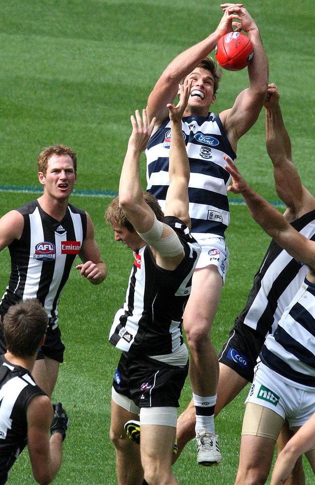 Tom Hawkins climbs over Ben Reid to mark during the 2011 grand final.