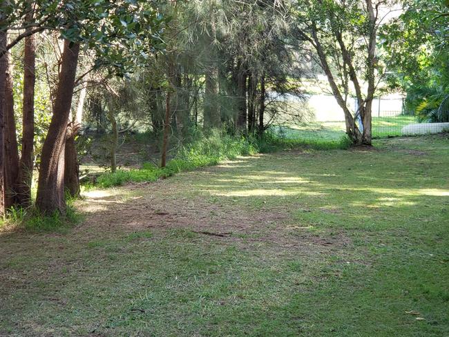 The unfenced waterfront land next to properties near Bill Mitchell Park.