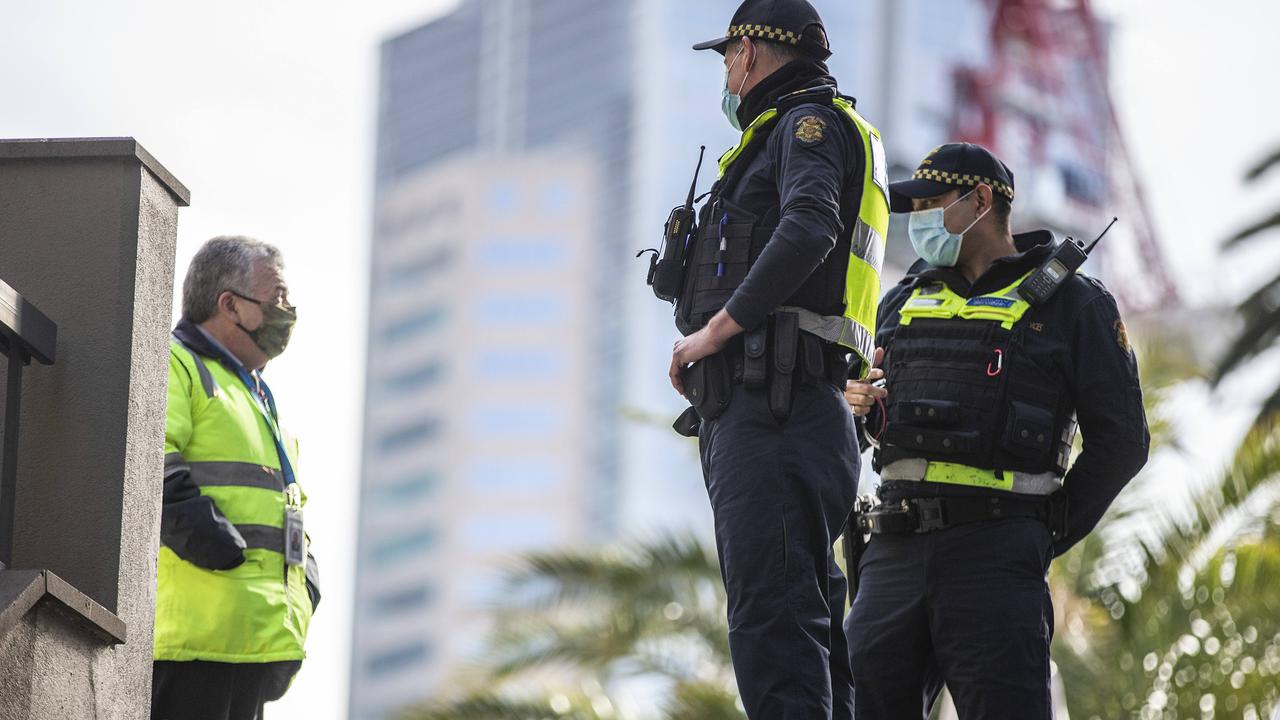 Police speak to a man in Melbourne while out patrolling the CBD for coronavirus restriction breaches. Picture: NCA NewsWire / Sarah Matray