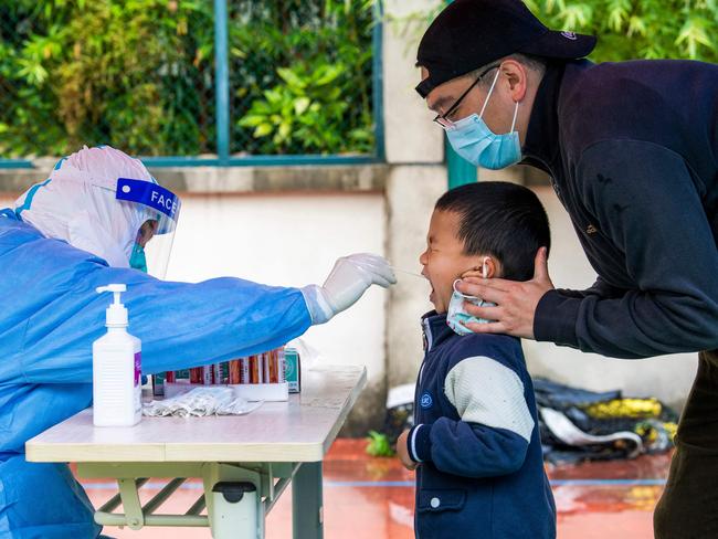 A child is tested for Covid-19 in a compound under lockdown in the Pudong district in Shanghai. Picture: AFP