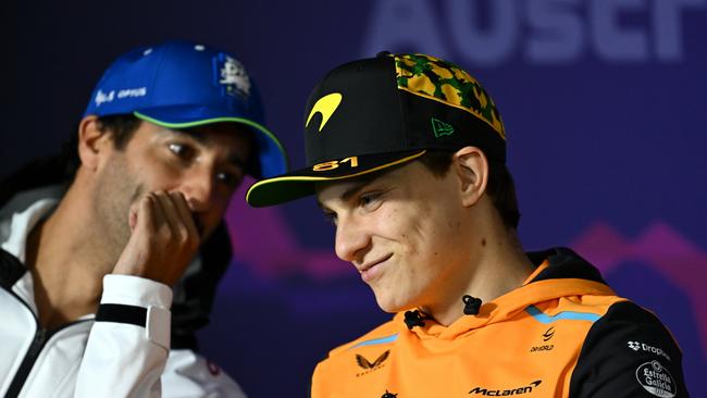 MELBOURNE, AUSTRALIA - MARCH 21: Daniel Ricciardo of Australia and Visa Cash App RB and Oscar Piastri of Australia and McLaren talk in the Drivers Press Conference during previews ahead of the F1 Grand Prix of Australia at Albert Park Circuit on March 21, 2024 in Melbourne, Australia. (Photo by Quinn Rooney/Getty Images)