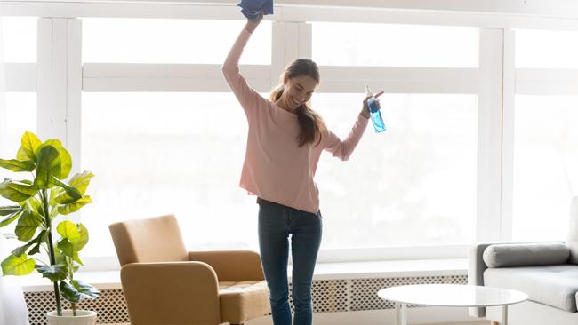 Full-length woman in casual clothes dance do house cleaning holds blue rag spray bottle detergent feels happy, qualified housekeeping specialist agency hiring, quick fast and easy home chores concept