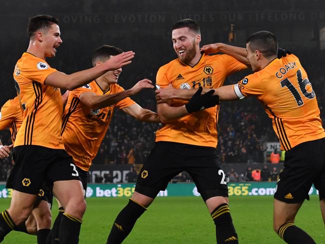 Wolverhampton Wanderers' Irish defender Matt Doherty (2R) celebrates after he scores his team's third goal during the English Premier League football match between Wolverhampton Wanderers and Manchester City at the Molineux stadium in Wolverhampton, central England  on December 27, 2019. (Photo by Paul ELLIS / AFP) / RESTRICTED TO EDITORIAL USE. No use with unauthorized audio, video, data, fixture lists, club/league logos or 'live' services. Online in-match use limited to 120 images. An additional 40 images may be used in extra time. No video emulation. Social media in-match use limited to 120 images. An additional 40 images may be used in extra time. No use in betting publications, games or single club/league/player publications. /