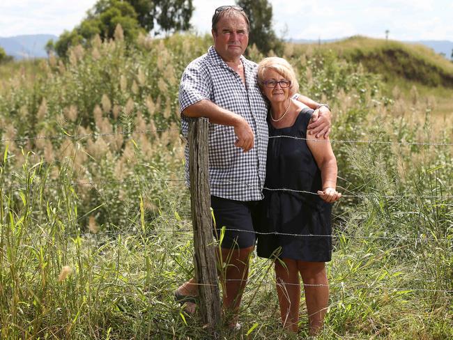 Grantham locals Tom and Sandra Friend with the Lockyer creek that runs behind their property , next to earthworks on the other side of the creek from a quarry that they believe made the flooding in the town worse in 2011. Grantham , QLD