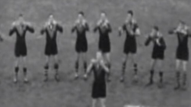 Kangaroos players do a war cry in the 1960s.