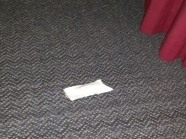 An alleged empty syringe packet on the floor.